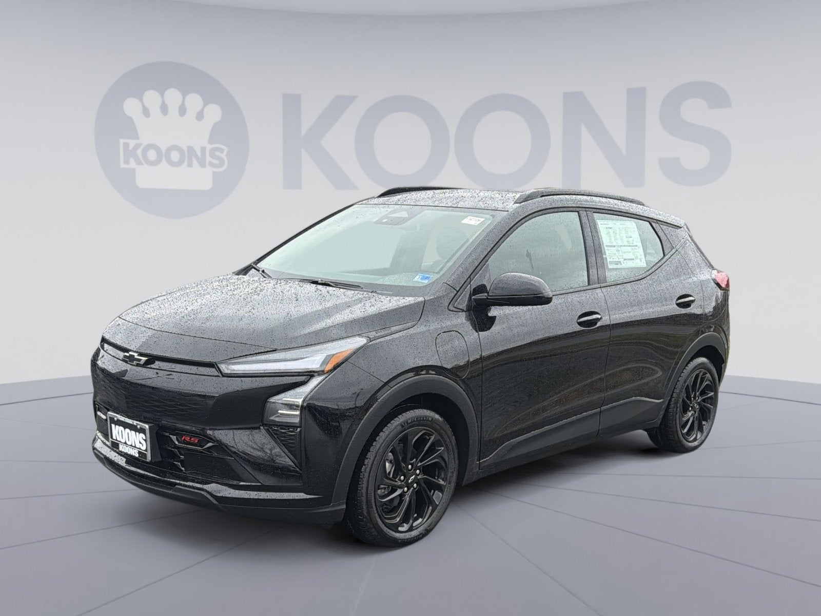 2027 Chevrolet Bolt RS in Mosaic Black Metallic — front three-quarter view